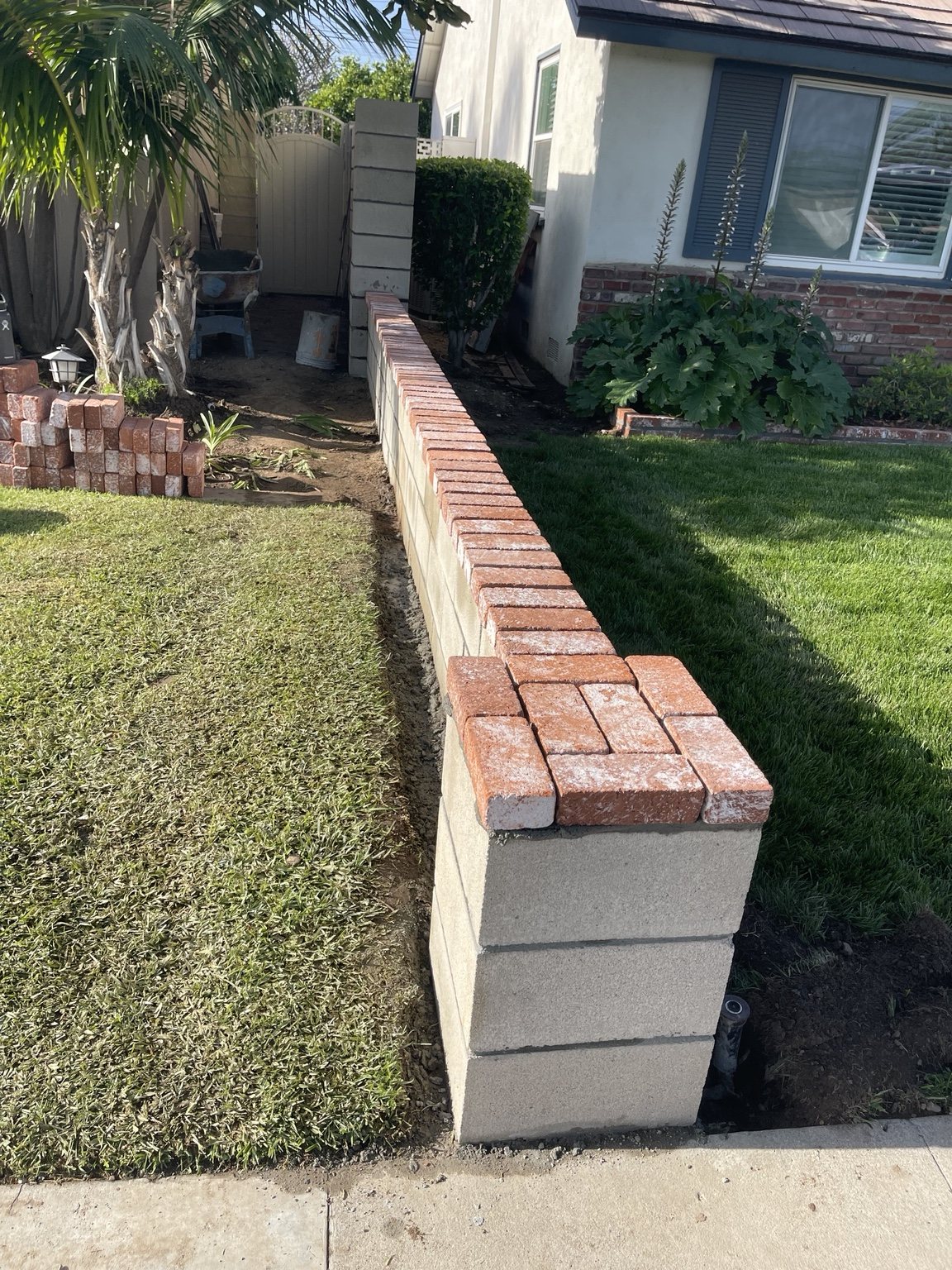 Block wall with red brick cap by RC Masonry in Orange County