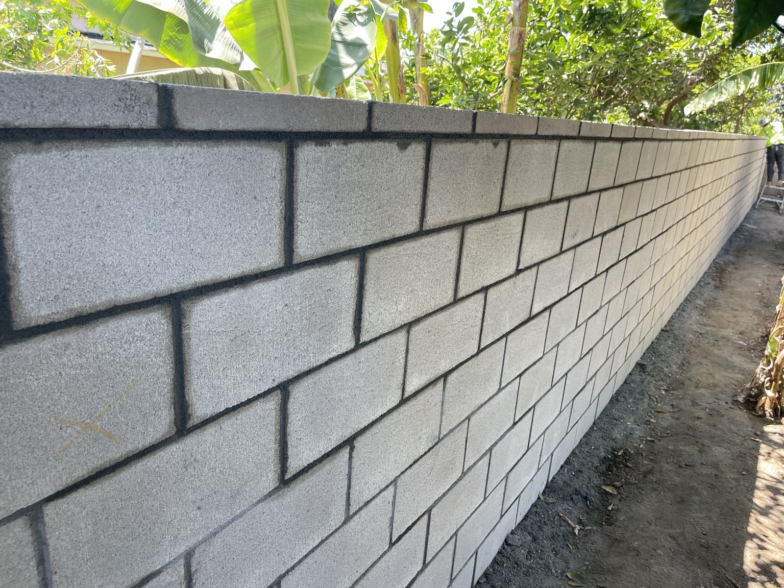 Long concrete block wall installation by RC Masonry in Orange County